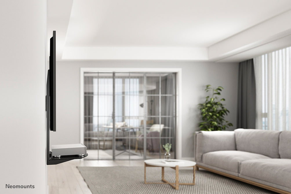 Support AV Neomounts, modèle NS-SHELF100, idéal pour le placement d'équipements AV sous des supports d'écran plat.
